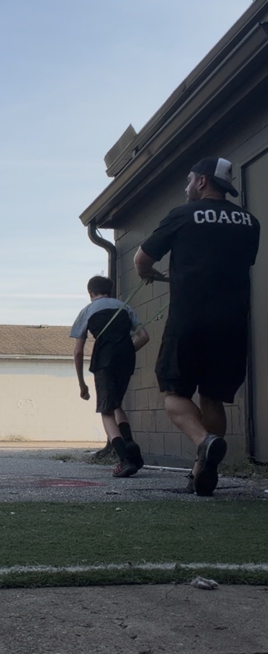 Joshua coaching a client through resisted band sprints