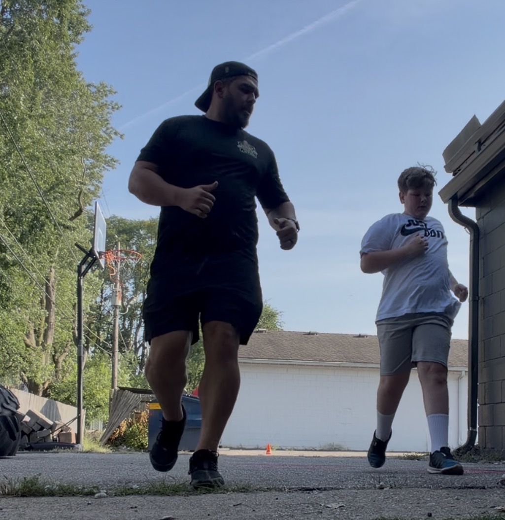 Joshua coaching a client through a conditioning run during a training session