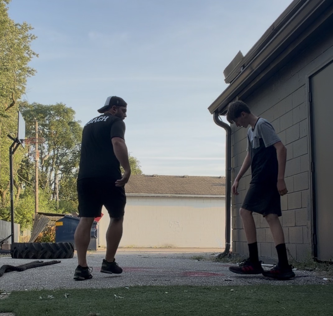 Joshua walking a client through a movement drill during a session