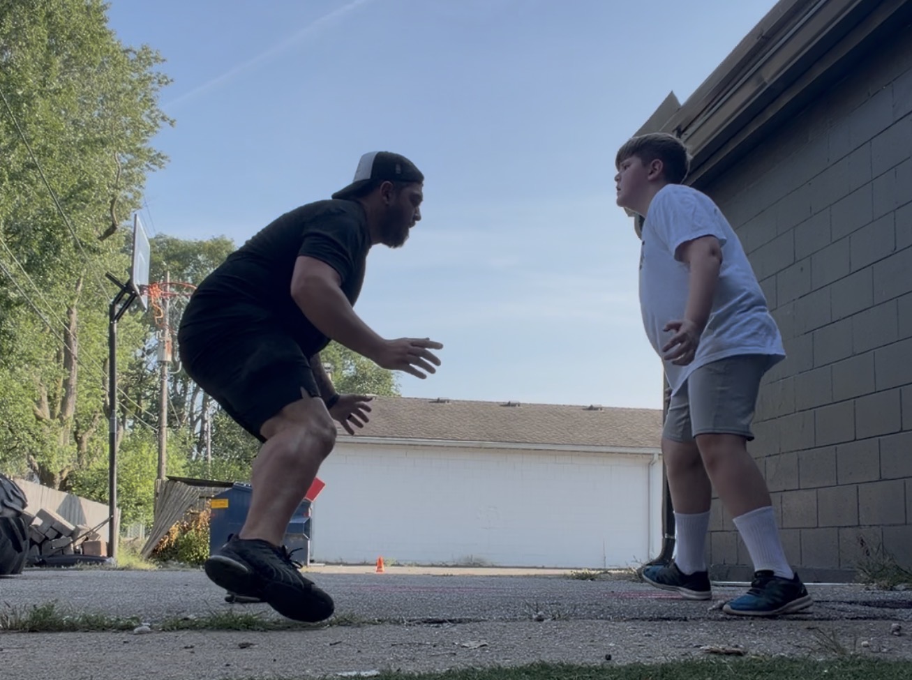 Joshua demonstrating athletic footwork drills with a young client